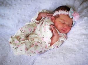 baby Greta sleeping in a beautiful onesie