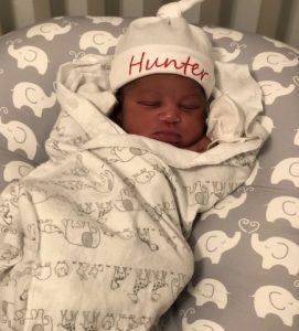 baby Hunter sleeping with a personalized bonnet