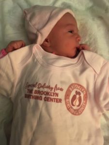 a newborn with a Brooklyn Birthing Center shirt