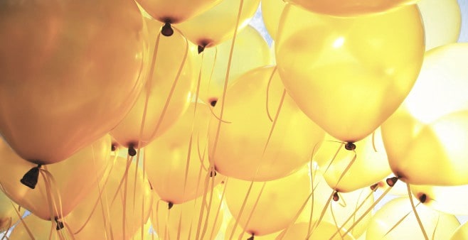 a cropped photo of yellow balloons