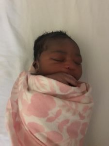 a sleeping newborn wrapped in a blanket